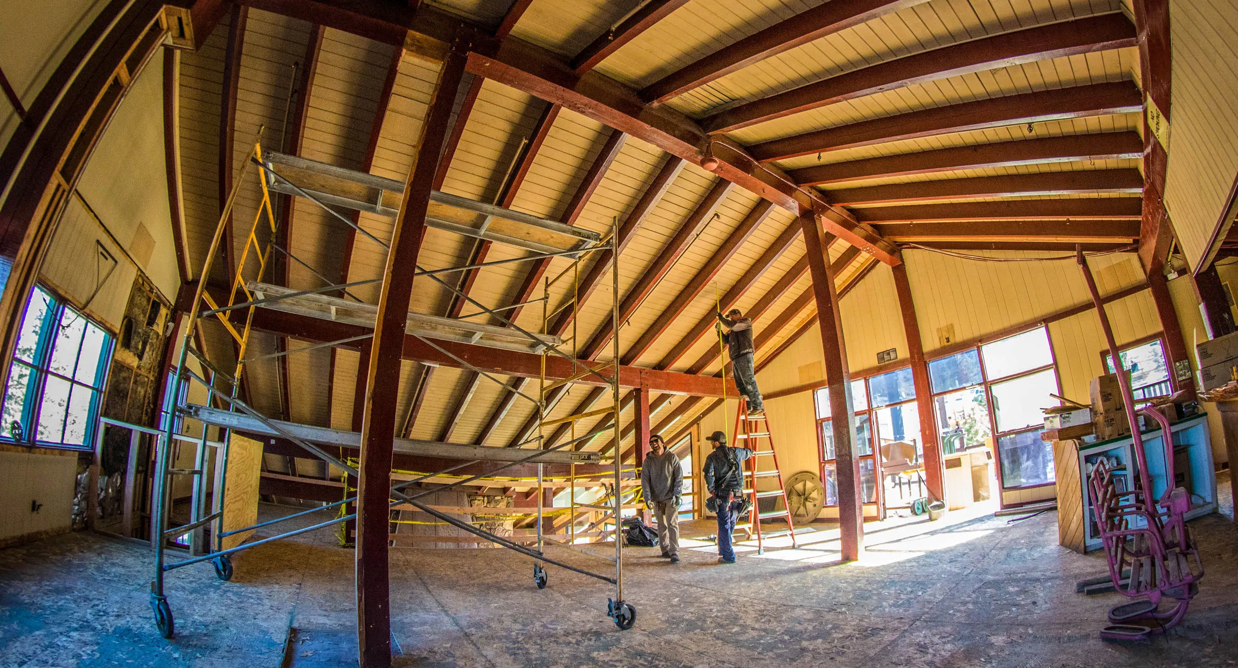 Construction workers working indoors, remodeling the ceiling